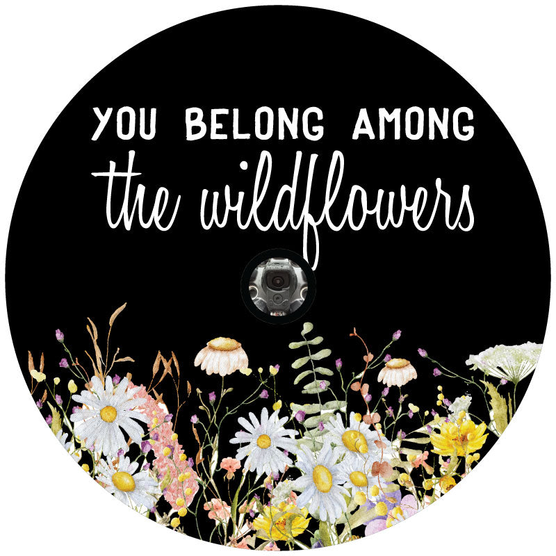 Mock up of a black vinyl spare tire cover design with colorful watercolor wildflowers and the saying, you belong among the wildflowers with a hole for a backup camera.