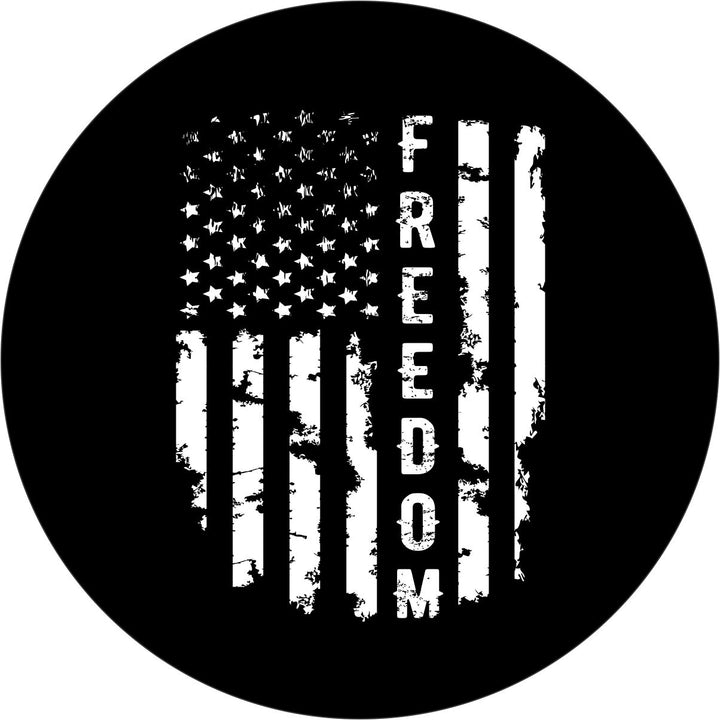 Black and white spare tire cover design of a vertical rustic looking American flag and the word freedom in place of one of the stripes written vertically down the flag.