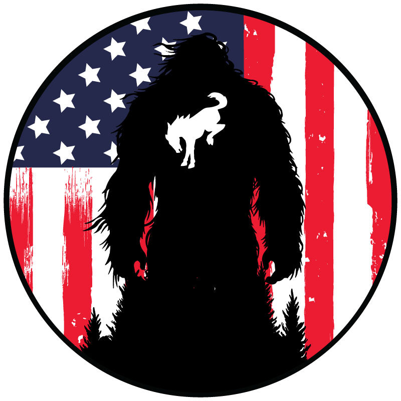 A spare tire cover design mockup of a rustic vertical  American flag background in red white and blue with a silhouette of Sasquatch and the bucking Bronco icon on bigfoot's chest.
