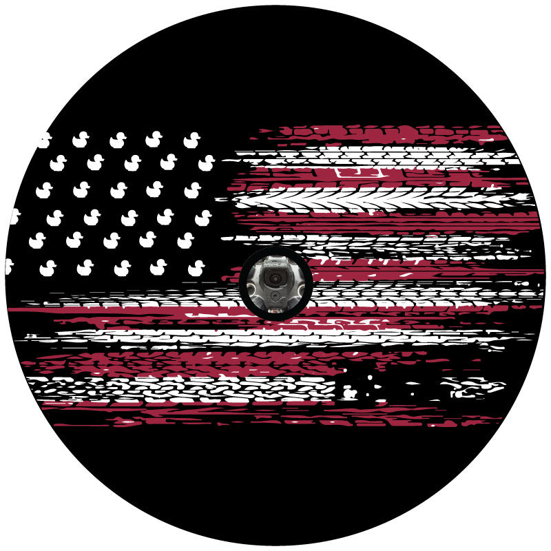 A unique  jeep spare tire cover design of a American flag with the stripes as red and white tire tracks and the stars traded out for ducks plus a hole to accommodate backup cameras
