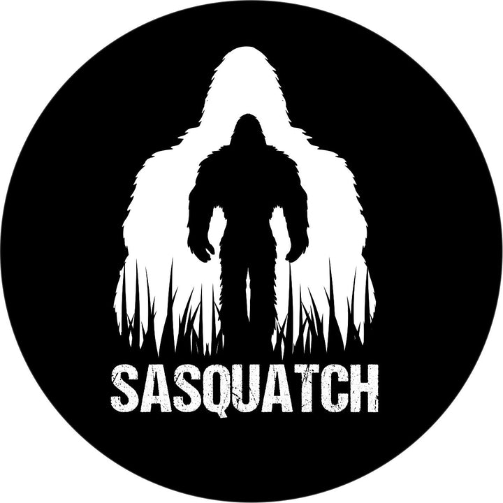 Vinyl spare tire cover design with Sasquatch silhouette double exposed in white and black with the word "Sasquatch" across the bottom. 