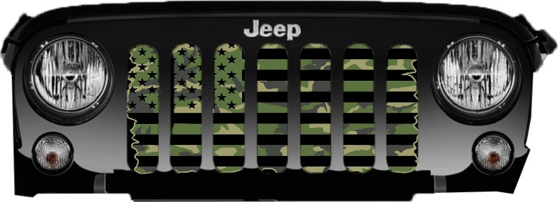 Just the grille of a Jeep Wrangler displaying a tactical black and camouflage American flag Jeep grille insert. 