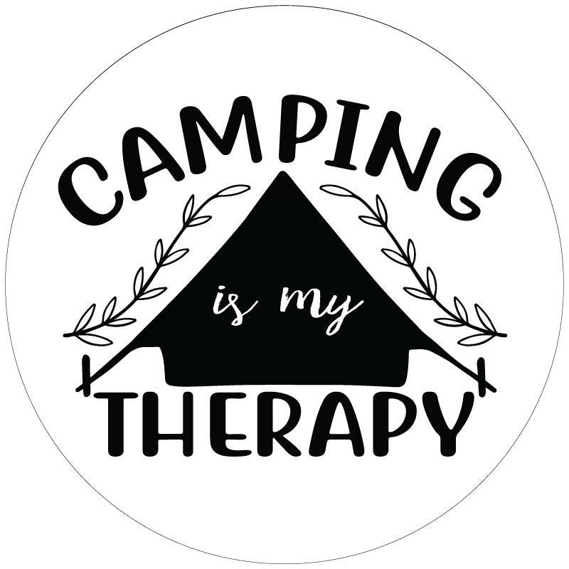 White spare tire cover with black tent silhouette design and the saying camping is my therapy.