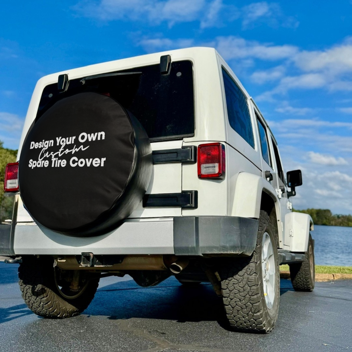 A white Jeep Wrangler showing the back to promote a design your own custom spare tire cover. 