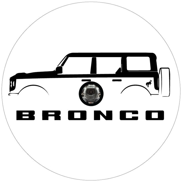 Mock up design of a custom white vinyl spare tire cover with a four door Ford Bronco silhouette, the Bronco letters below and the bucking bronco horse detail on the back fender, plus a center hole cut out for a backup camera.