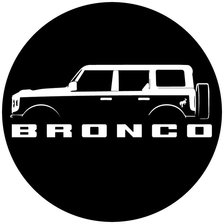 Mock up design of a custom black vinyl spare tire cover with a four door Ford Bronco silhouette, the Bronco letters below and the bucking bronco horse detail on the back fender.