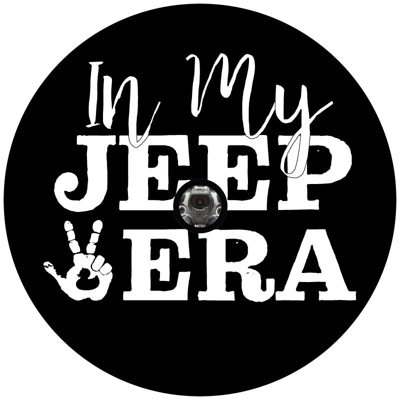 Spare tire cover design mock up that says in my Jeep Era with an image of a hand doing the Jeep wave and a duck silhouette on the palm with a middle hole for a back up camera. 