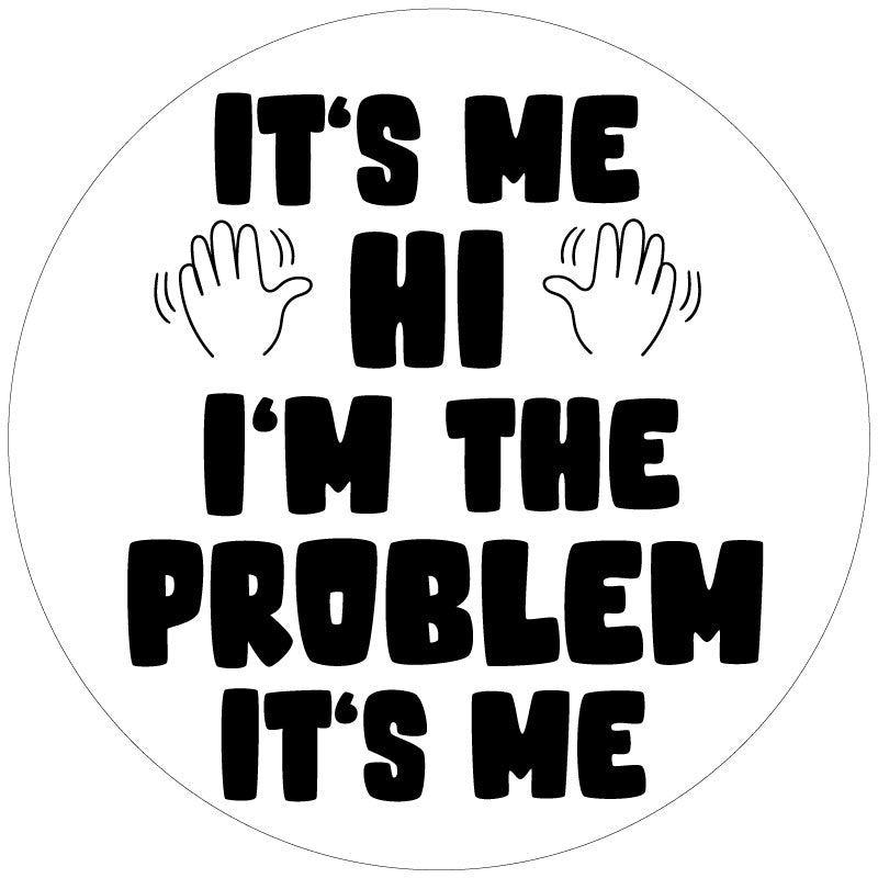 White vinyl spare tire cover with black text of the Taylor Swift song lyrics, It's Me. Hi. I'm The Problem It's Me and two hands waving