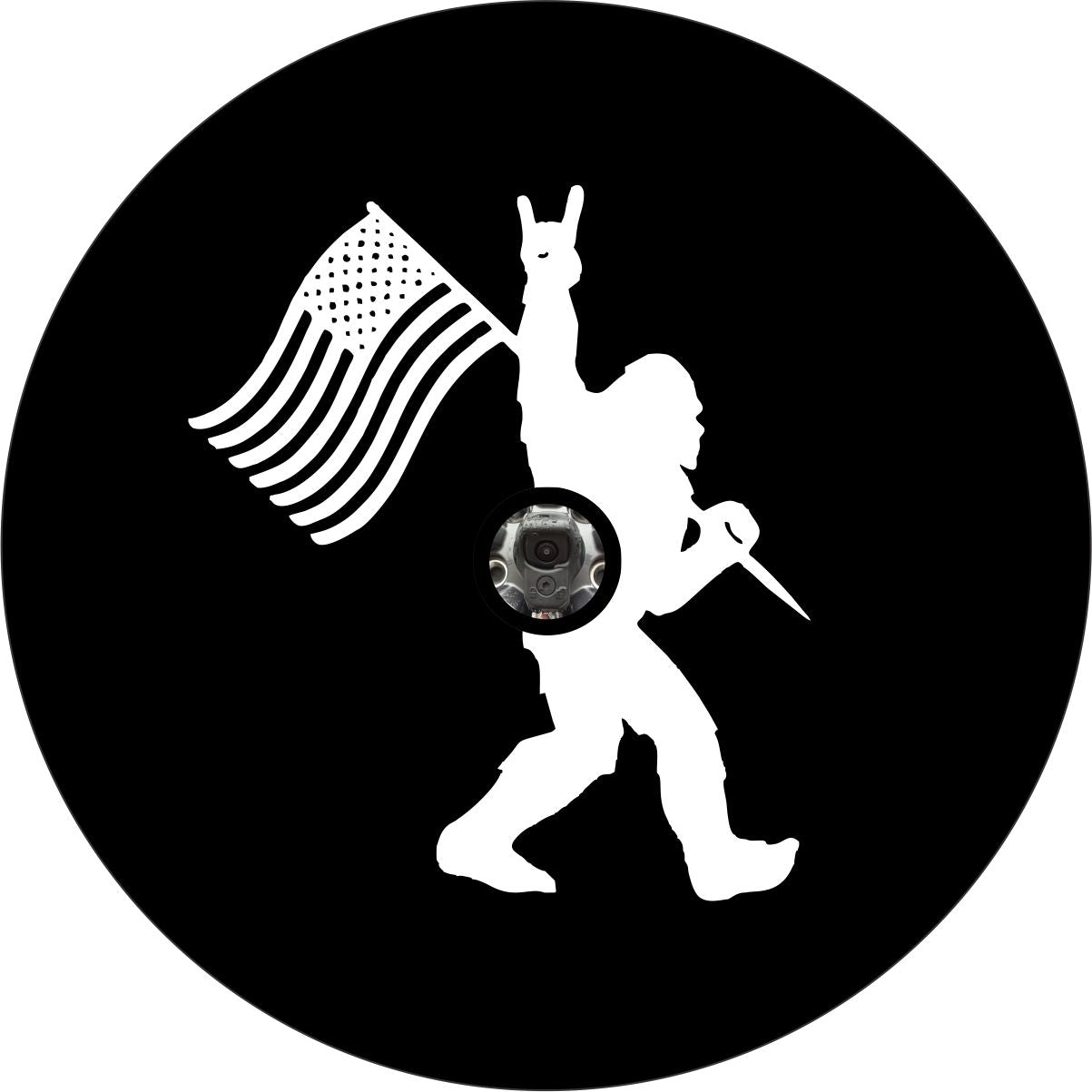 Spare tire cover design of Sasquatch walking by holding the American flag and throwing up the rock on sign with his hand and a hole for a back up camera.