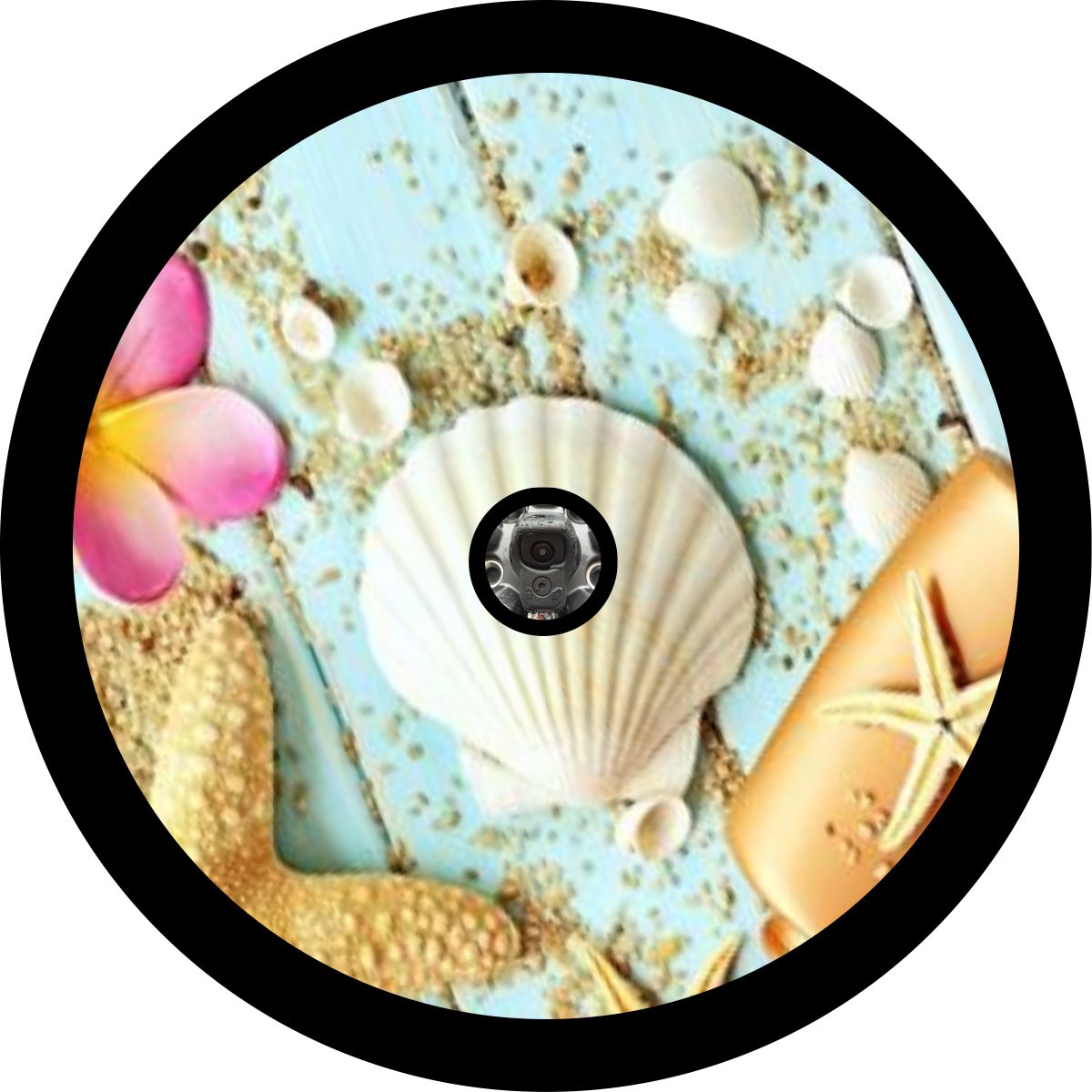 A spare tire cover mock up design of seashells, plumeria flower, starfish, and sand on wood with a center hole for a backup camera