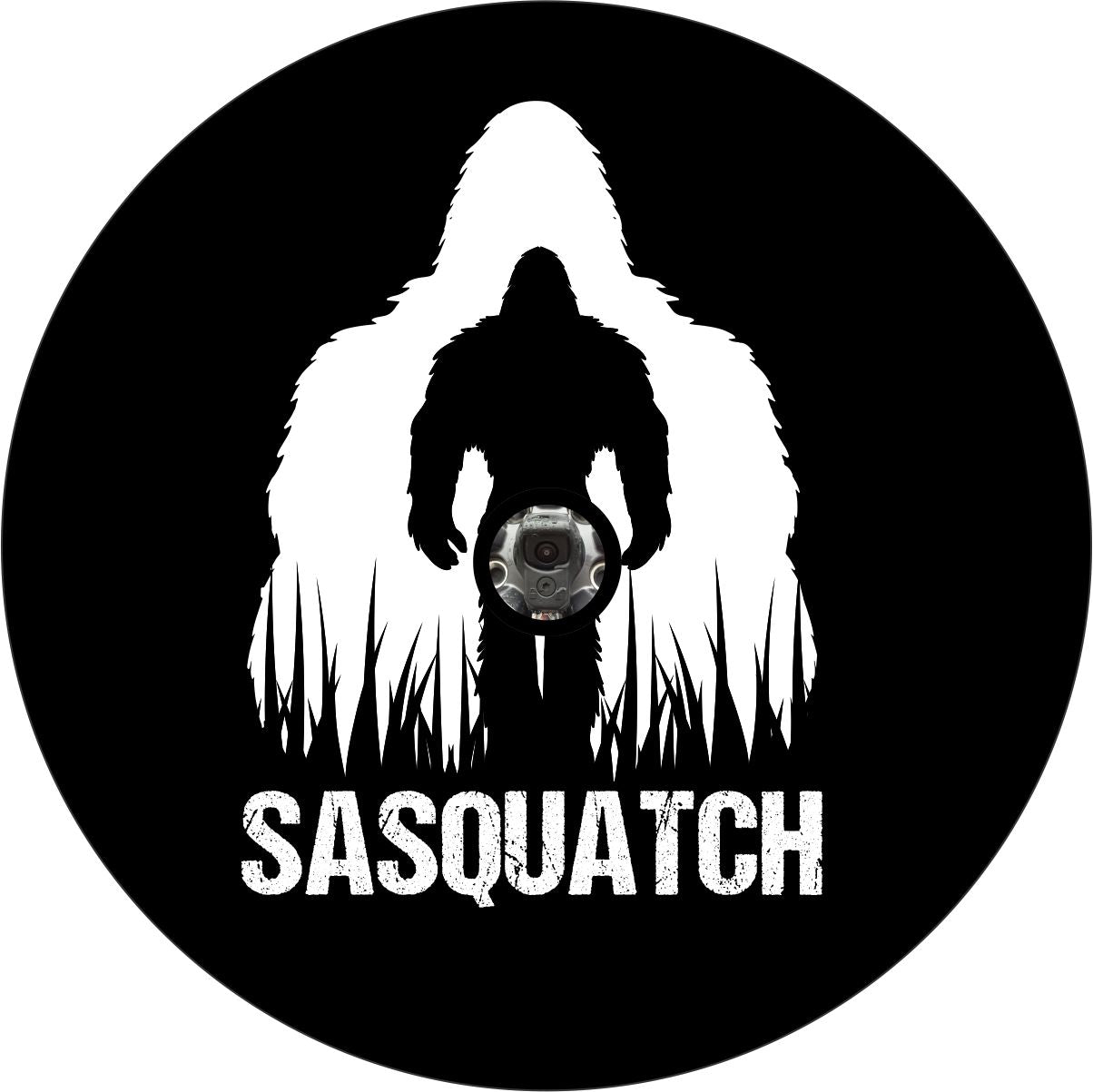 Vinyl spare tire cover design with Sasquatch silhouette double exposed in white and black with the word "Sasquatch" across the bottom and a hole for a vehicle that has a back up camera in their spare wheel.