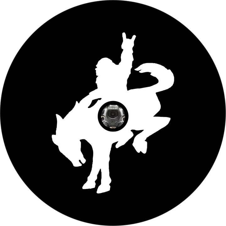 Black vinyl funny spare tire cover of a sasquatch riding a bucking bronco with a camera hole for a back up camera.