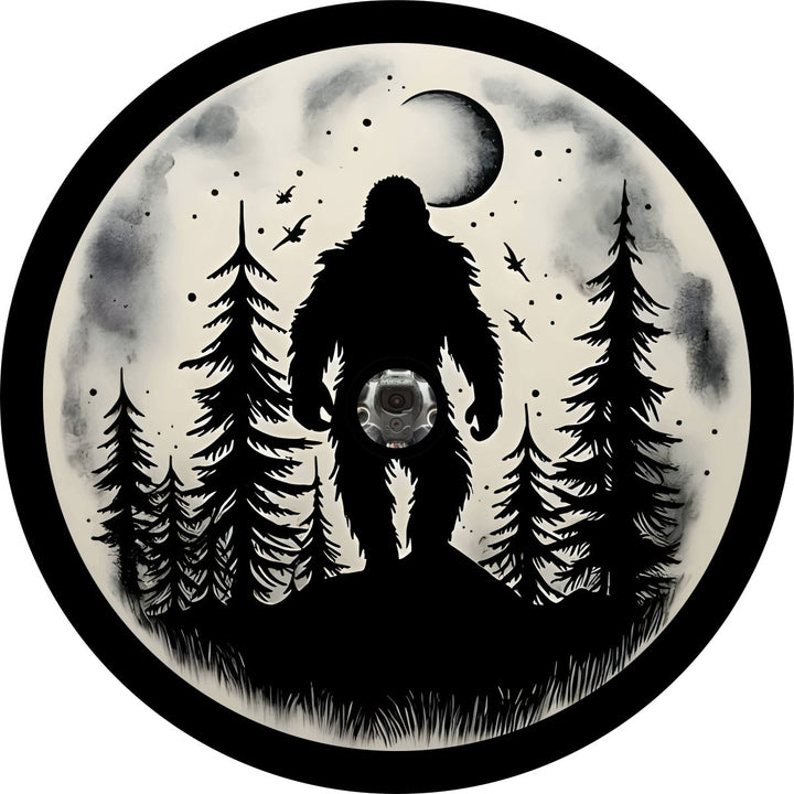 Create sasquatch spare tire cover design with a silhouette of bigfoot walking through the forest under the full moon with a hole placement for a backup camera