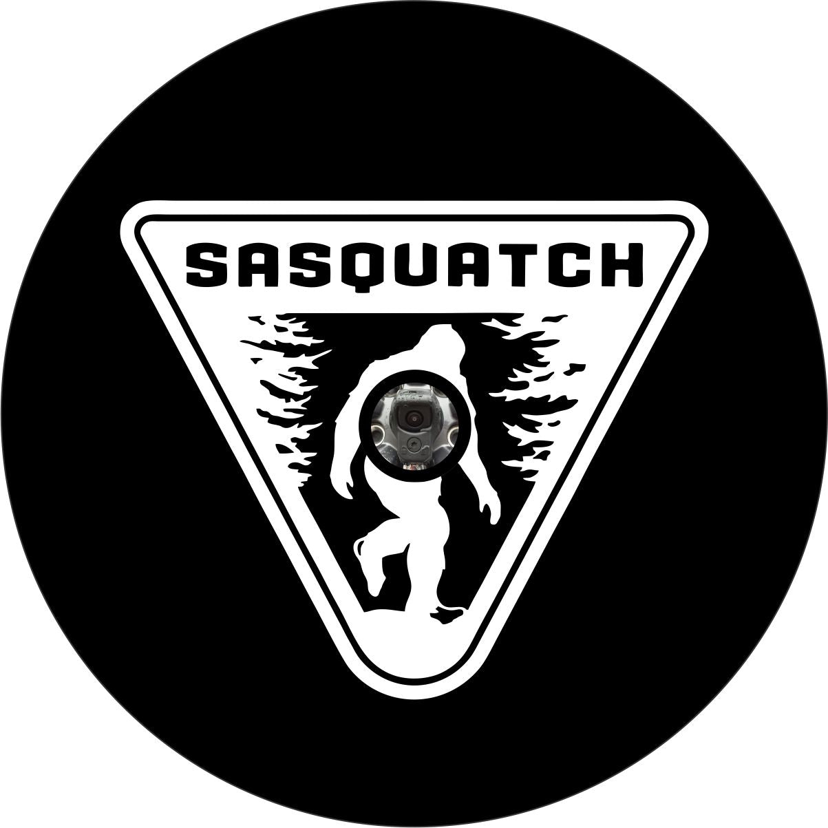 Mock up for a black vinyl Sasquatch spare tire cover design. White upside down triangle sign with a bigfoot silhouette and the work Sasquatch across the top with a hole in the center intended for vehicle makes and models that have a backup camera on their spare tire.