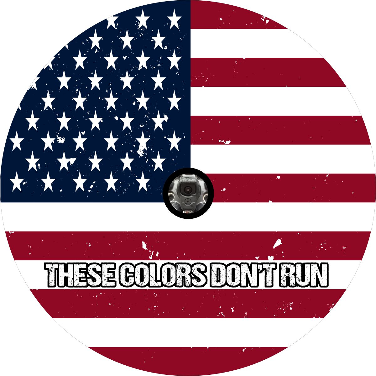 Round red, white, and blue American flag with the words, "these colors don't run" typed on the bottom, designed as a spare tire cover with a hole for a backup camera for a Jeep, Bronco, RV, FJ Cruiser, Rav4, Honda CR-V, Camper, Van, or any other vehicle that has a exterior spare wheel in need of covering.