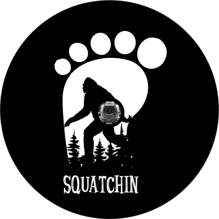 Footprint silhouette with sasquatch walking by and trees in the background plus a hole for a back up camera.