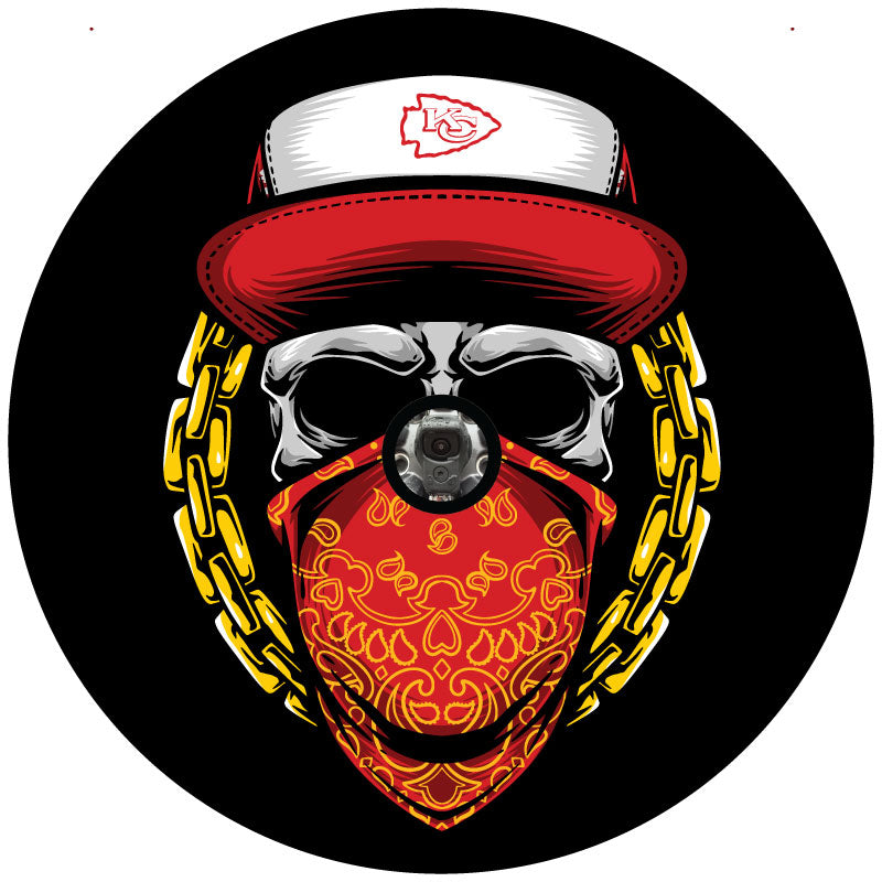 A skull wearing a red and yellow bandana and a red Kansas City Chiefs hat design for a spare tire cover on a Jeep, Bronco, Camper, RV, Van, and more plus a hole to accommodate a backup camera. 