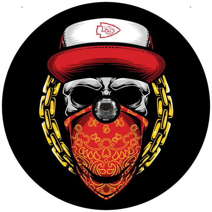 A skull wearing a red and yellow bandana and a red Kansas City Chiefs hat design for a spare tire cover on a Jeep, Bronco, Camper, RV, Van, and more plus a hole to accommodate a backup camera. 