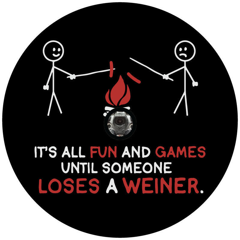 Funny spare tire cover design with a hole for a backup camera port of two stick figures around a campfire roasting hotdogs with one hotdog falling into the fire and the saying, it's all fun and games until someone loses a weiner.