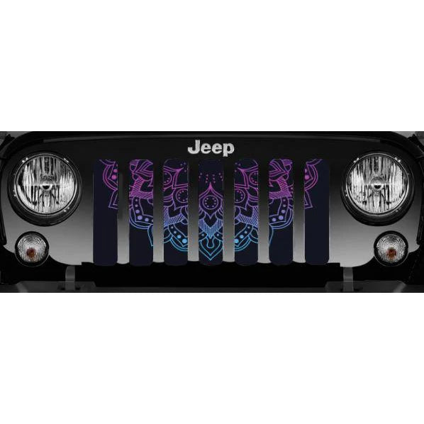 Close up view of a purple and Blue ombre colored lotus mandala flower design on a grille insert for a Jeep Wrangler displayed on a black Jeep Wrangler