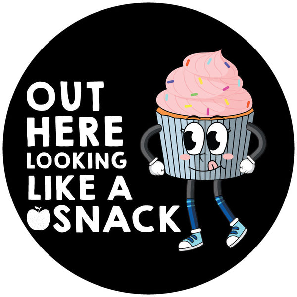 A spare tire cover design for a soft black vinyl spare tire cover with a cute pink cupcake character and the text or saying "out here looking like a snack"