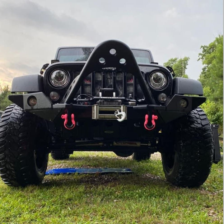 Black Jeep Wrangler with hot pink accents and mods showing a Jeep grille insert of a gray skeleton with bright pink eyes looking at you. 