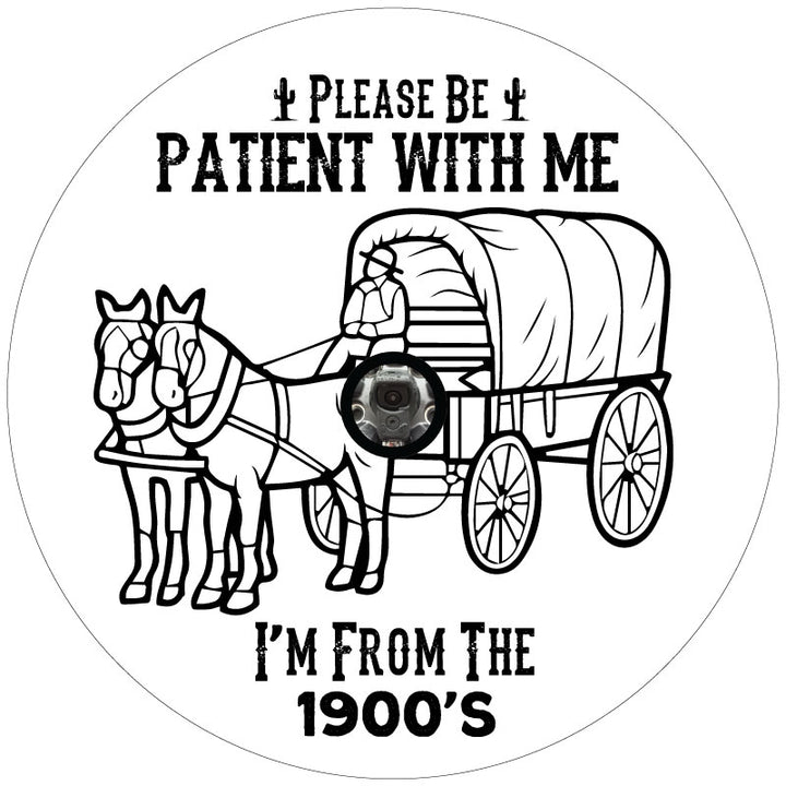 A spare tire cover design for an external spare wheel with a backup camera that says please be patient with me I'm from the 1900's and a silhouette of a covered wagon and horses.