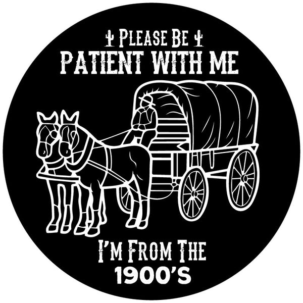 A spare tire cover design that says please be patient with me I'm from the 1900's and a silhouette of a covered wagon and horses.