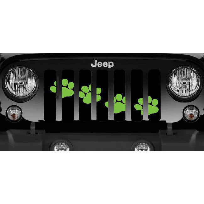 Close up view of a Black Jeep Wrangler from the front showing a paw print Jeep grille insert design