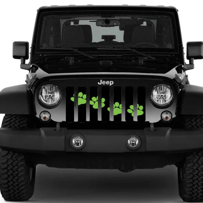 Black Jeep Wrangler from the front showing a paw print Jeep grille insert design