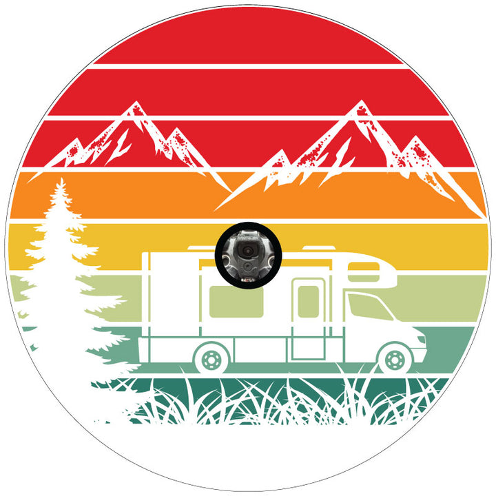 Mockup example of a white vinyl spare tire cover design for a motorcoach or RV camper. Colorful striped background with silhouettes of mountains, RV, and nature. Design works for spare wheels with a backup camera