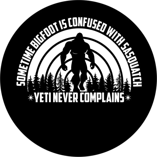 Mockup design of a black vinyl spare tire cover with a funny saying, "Sometime bigfoot is confused with Sasquatch, Yeti never complains" and a silhouette of sasquatch in the background.