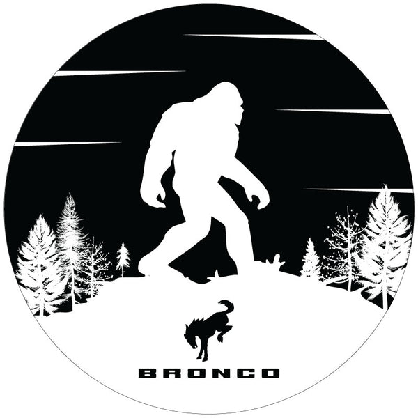 Black vinyl spare tire cover with a white and black silhouette of a bigfoot sasquatch and a Ford Bronco logo design custom made for a Ford Bronco Sasquatch spare tire.