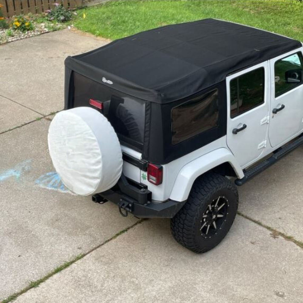 All white vinyl spare tire cover on a white Jeep Wrangler with a black soft top 