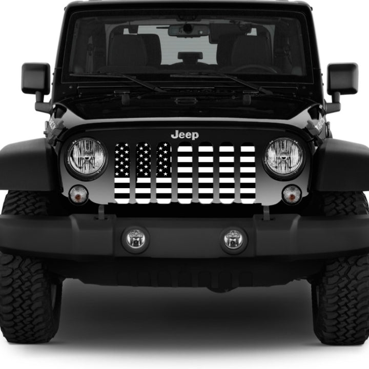 Tactical American flag Jeep Wrangler grille insert on a black Jeep Wrangler with a plain white background