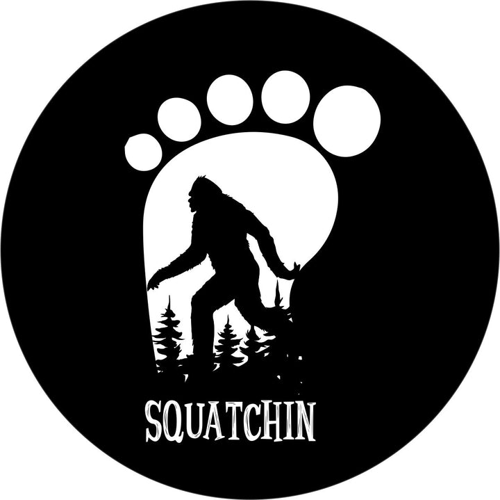 Footprint silhouette with sasquatch walking by and trees in the background. 