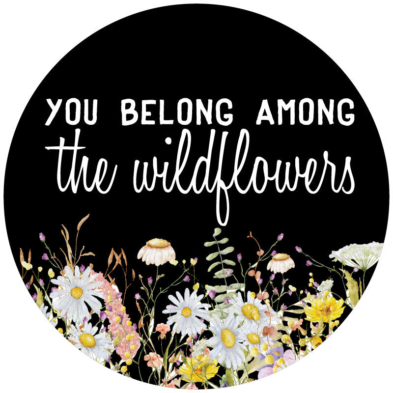 Mock up of a black vinyl spare tire cover design with colorful watercolor wildflowers and the saying, you belong among the wildflowers. 