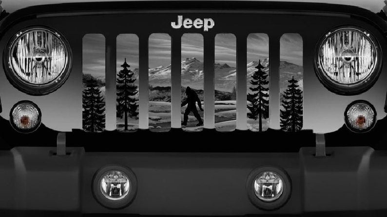 Up close look of the designed mesh Jeep grille insert of Sasquatch walking through the woods and mountains