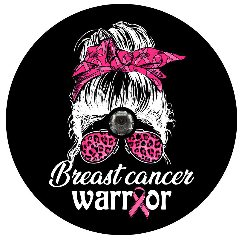 Spare tire cover for campers, RV, Jeep, Broncos, trailers, and more. Design is a silhouette of a girl with a messy bun top knot and a breast cancer pink ribbon hair ribbon with pink leopard sunglasses plus the words breast cancer warrior for black vinyl spare tire cover with back up camera hole