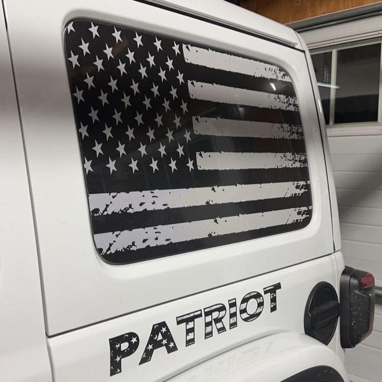 Black and white distressed American flag window cling for a Jeep Wrangler back window on a hard top. 