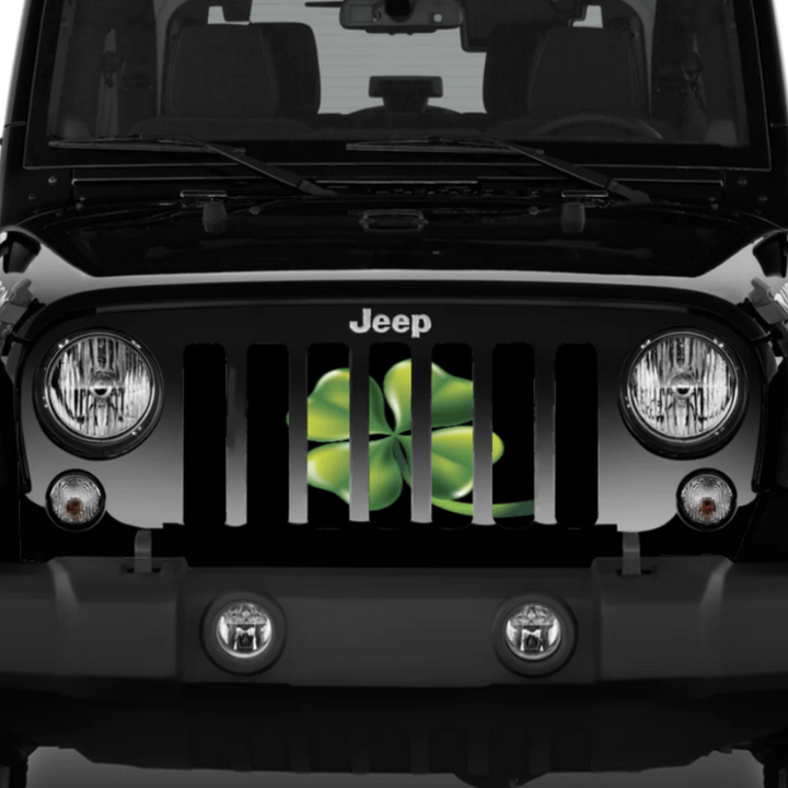 Black Jeep Wrangler displaying a green four leaf clover shamrock designed Jeep grille insert