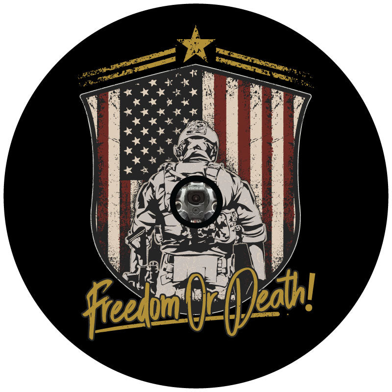 American flag insignia with a silhouette of the back of a soldier in front of the flag with the saying Freedom or Death in script on a black vinyl spare tire cover for Jeep, Bronco, RV, Camper, Van, and more designed for a JL back up camera
