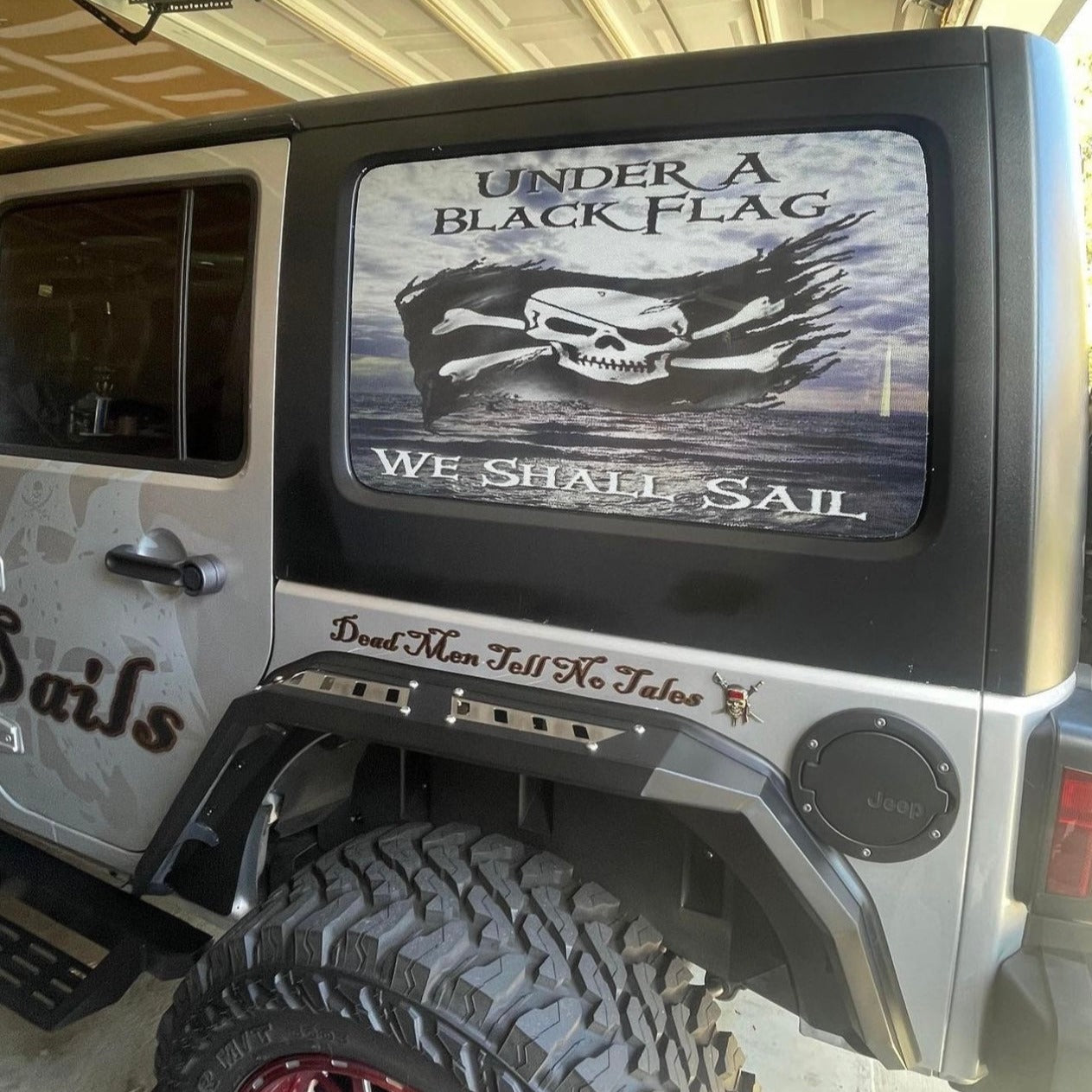 Pirate Jeep Wrangler window decal with a skull and cross bones priate flag and the words under a black flag we shall sail.