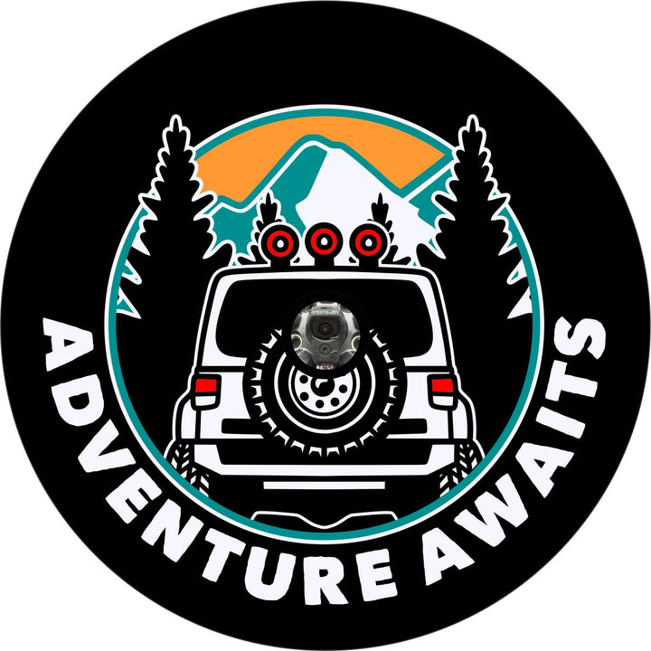 Spare tire cover design with a camera hole for back up cameras of the back side silhouette of a Jeep Wrangler driving into the mountains with the words adventure awaits below.