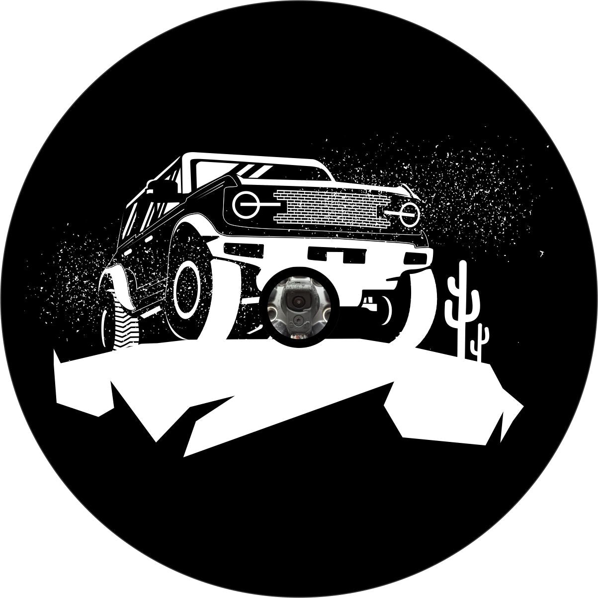 Spare tire cover of a Ford Bronco on a cliff in the desert with cactus. Bronco spare tire cover for backup camera. Camera hole is made in this tire cover to accommodate a Bronco back up camera