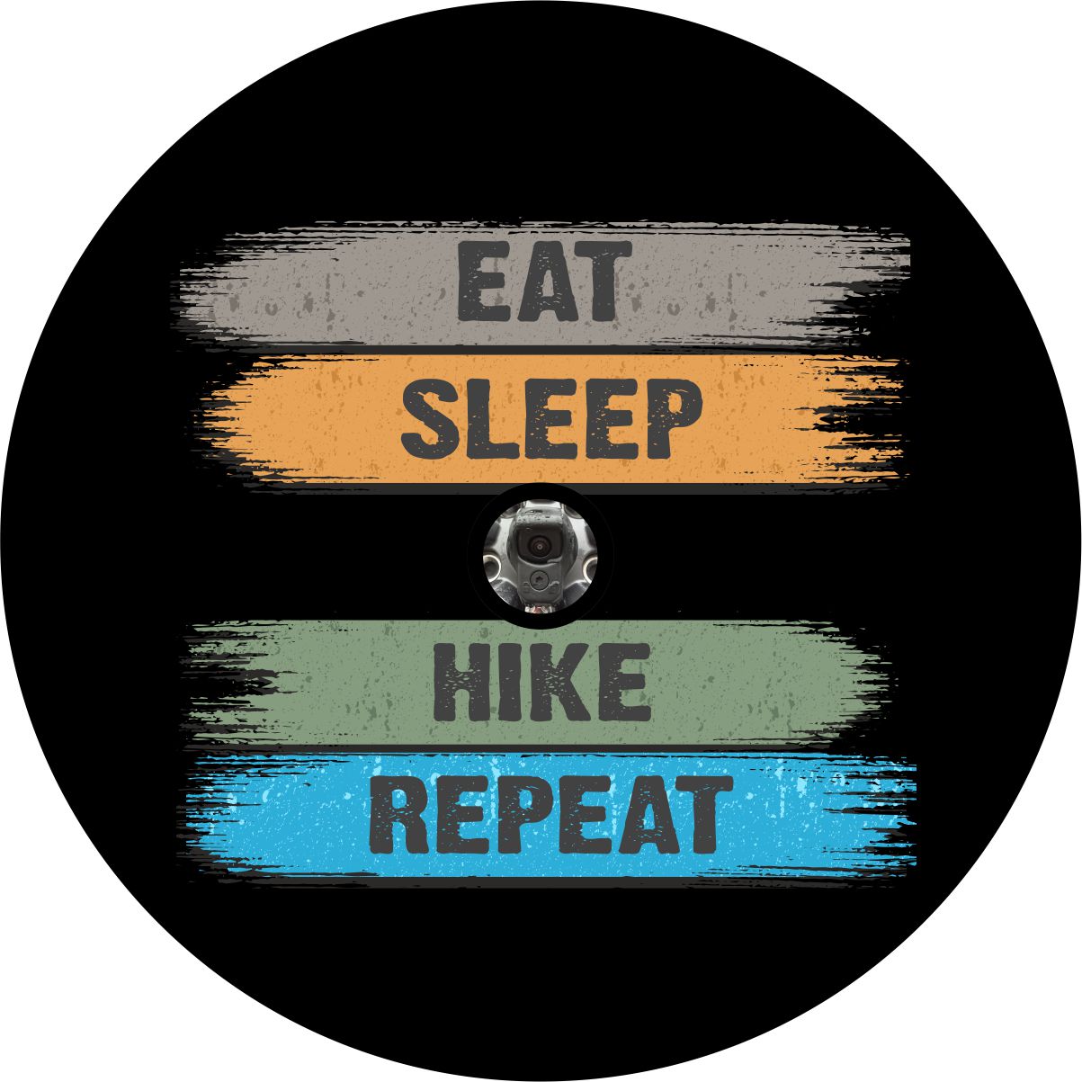 Spare tire cover with a brushed design and the words eat, sleep, hike, repeat. Spare tire cover is made to order for a JL backup camera. 