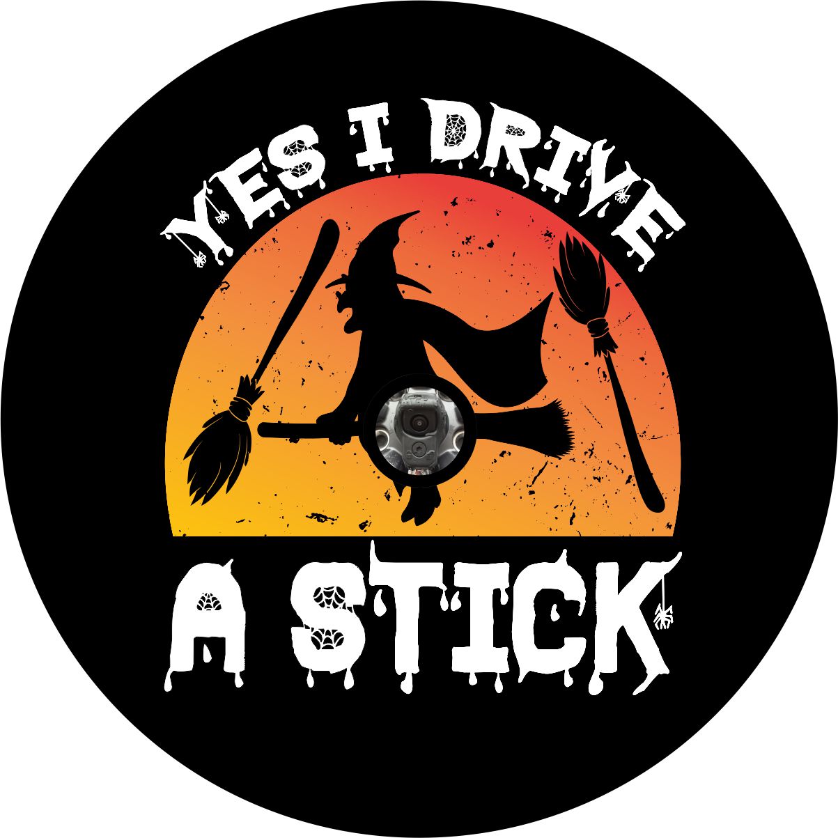 Silhouette of a watch flying on a broom with orange gradient and the saying "yes I drive a stick" in spooky text as a spare tire cover design for Jeep, RV, Bronco, Camper, and more with a back up camera