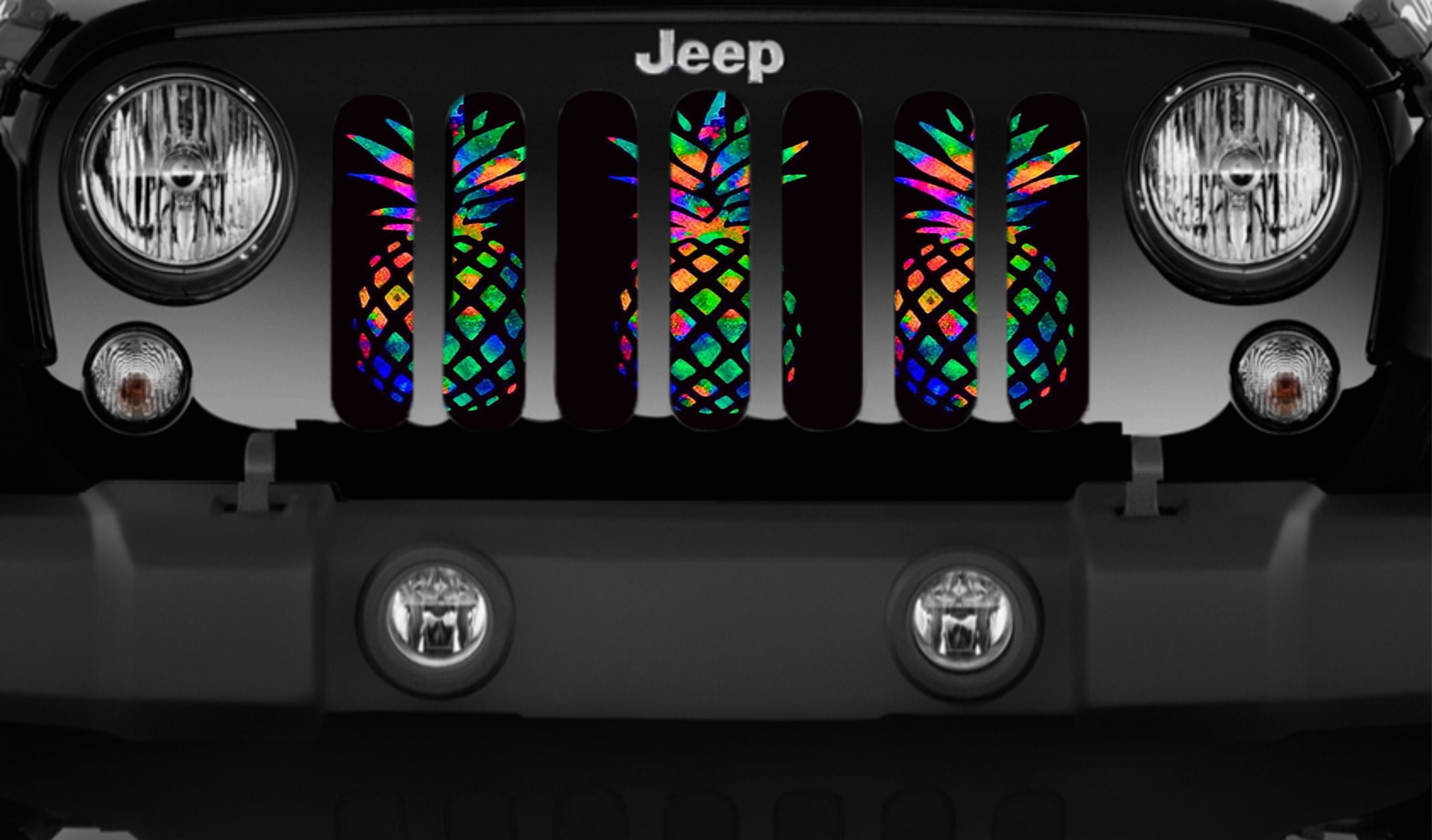 Close up view of a black Jeep showcasing a fun fluorescent bright neon colored pineapple design grille insert for Jeep. 