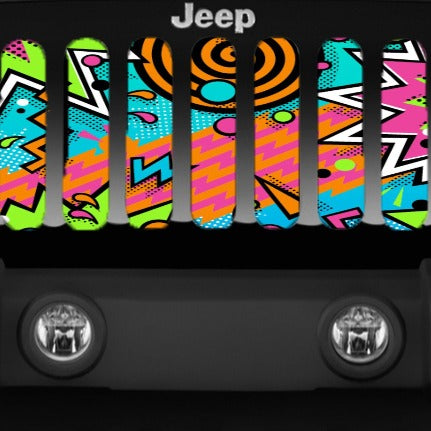 Close up Jeep grille insert design with an array of geometric shapes and a variety of colors. Very 90's retro pattern Jeep grille insert displayed on a black Jeep Wrangler.
