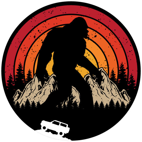 A retro vintage spare tire cover design with Sasquatch or bigfoot walking through the mountains and the silhouette of a Ford Bronco driving.  Designed for a black vinyl spare tire cover
